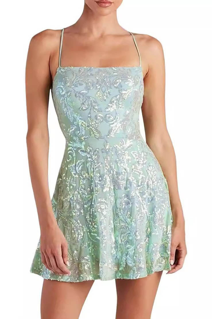 Green - Full-length view of a model wearing a black A-line mini dress with spaghetti straps and a square neckline, featuring an all-over black sequin baroque pattern.