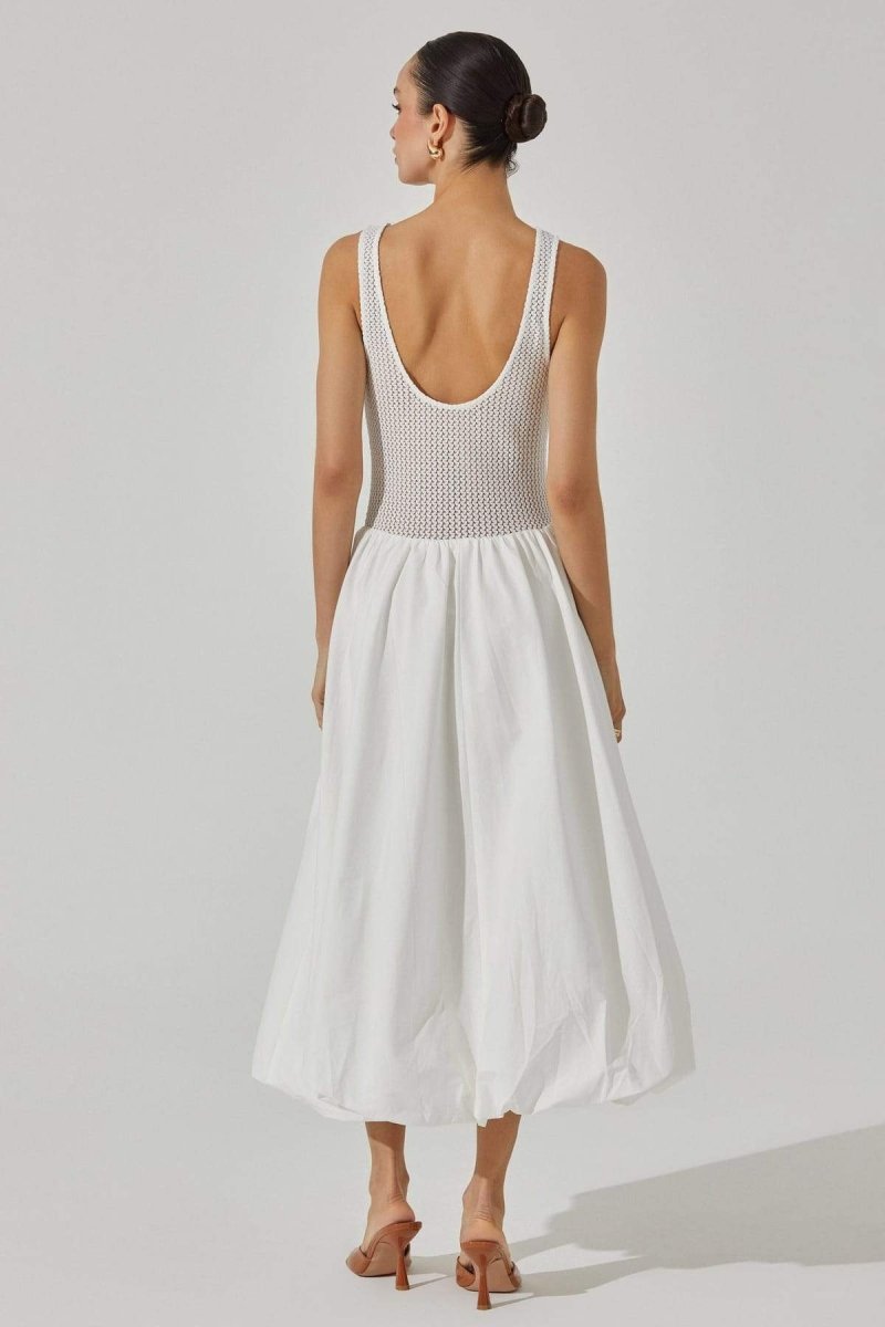 White - A woman stands against a white background wearing a sleeveless white midi dress. The dress has a textured open-knit tank-style bodice and a full, smooth A-line skirt that ends mid-calf.