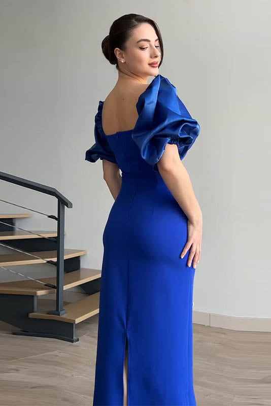 Blue - A woman wearing an elegant deep red midi dress featuring large, shiny puff sleeves, a square neckline, and scattered pearl-like embellishments, paired with silver heels and a matching clutch.