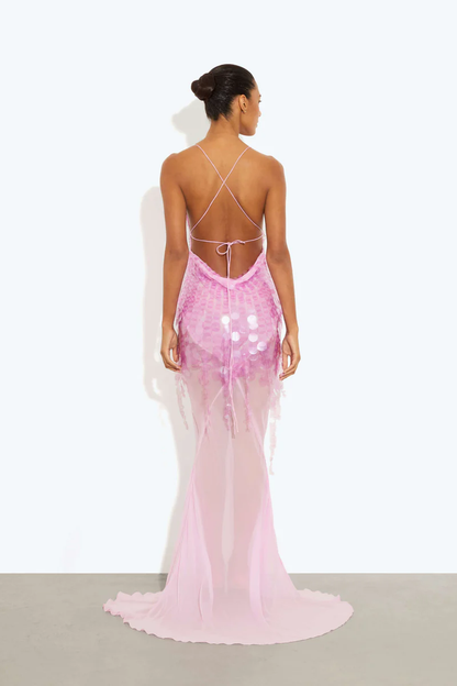 Pink - A model wearing a women's sheer pink maxi dress featuring a plunging V-neckline, delicate straps, and large sequin embellishments cascading down the bodice.