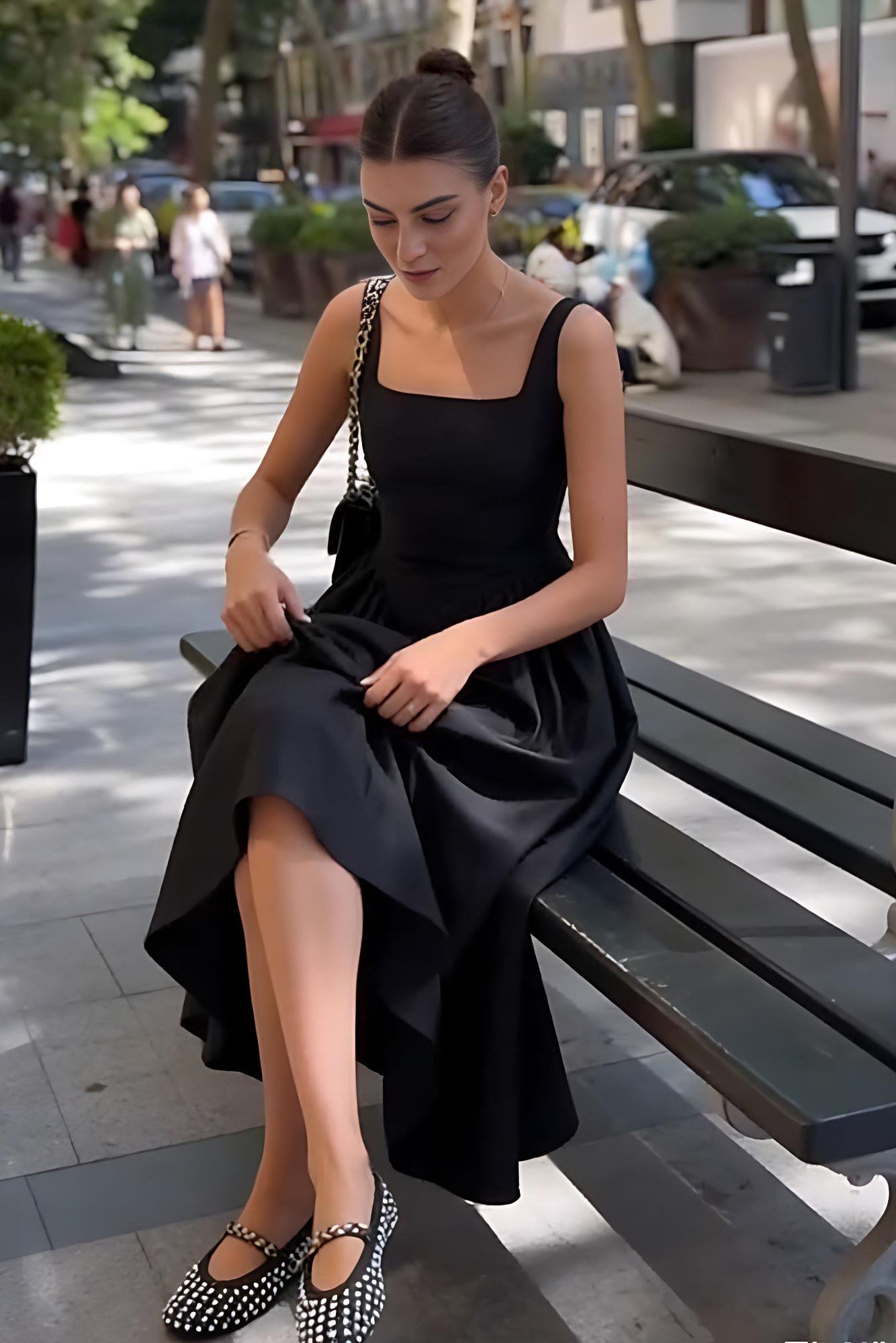 Black - A woman walking outdoors wearing an elegant black sleeveless midi dress featuring a square neckline, fitted bodice, and a full gathered skirt with a dropped waist.