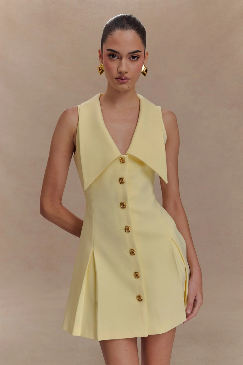 Lemon - Women's pale yellow sleeveless mini dress featuring an oversized pointed collar, metallic button-down front, and a structured pleated skirt.