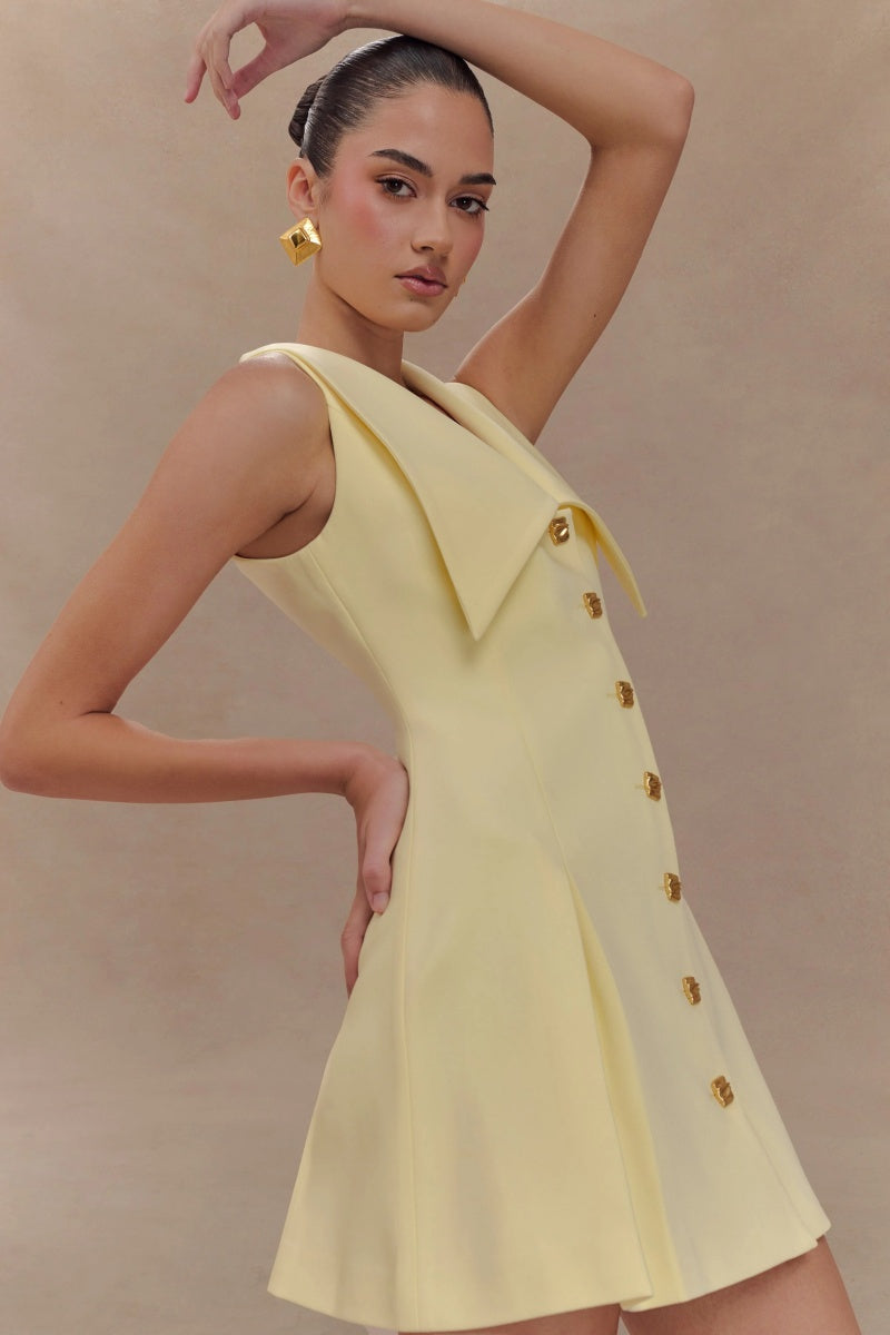 Lemon - Women's pale yellow sleeveless mini dress featuring an oversized pointed collar, metallic button-down front, and a structured pleated skirt.