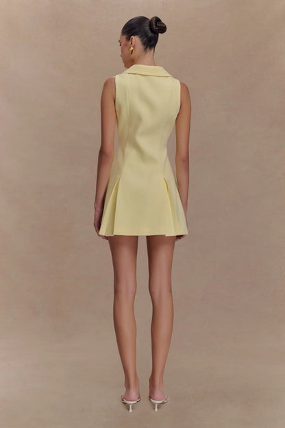 Lemon - Women's pale yellow sleeveless mini dress featuring an oversized pointed collar, metallic button-down front, and a structured pleated skirt.