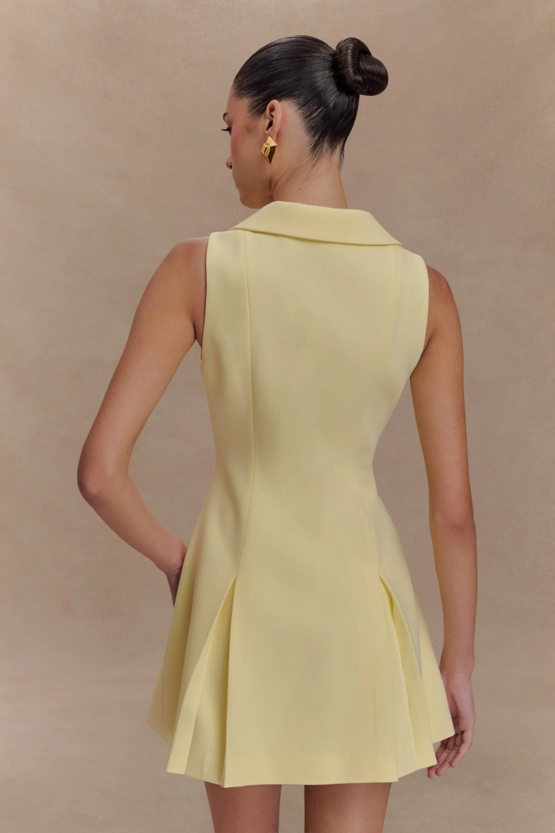 Lemon - Women's pale yellow sleeveless mini dress featuring an oversized pointed collar, metallic button-down front, and a structured pleated skirt.