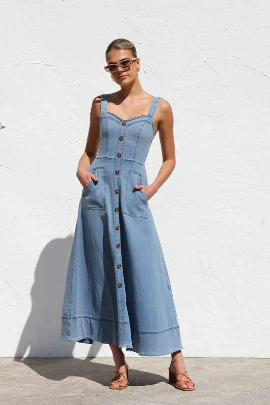 Women's blue structured midi dress featuring a full button-front, wide straps, sweetheart neckline, and front patch pockets.