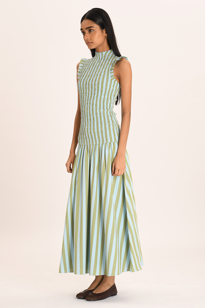 Green - Women's sleeveless maxi dress featuring a high neck, smocked bodice, ruffled shoulders, and a drop-waist gathered skirt in a light blue and olive green vertical stripe pattern.