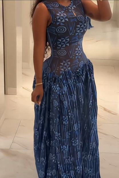 Blue - A woman wearing a sleeveless maxi dress featuring a fitted, semi-sheer geometric bodice and a voluminous gathered skirt with a mixed abstract blue print.