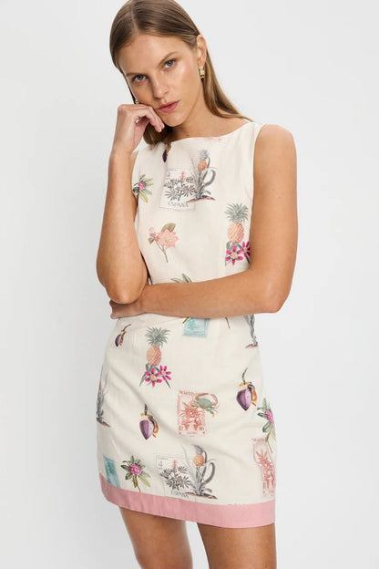 Women's sleeveless mini shift dress in cream featuring a vintage botanical and stamp print with a solid pink contrast hem.