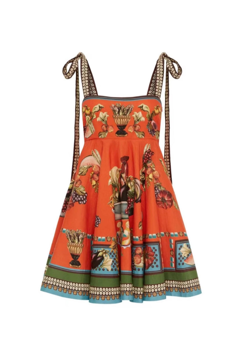 Orange color - Women's vibrant mini dress featuring a square neckline, tie-shoulder straps, a flared skirt, and an ornate still-life and fruit print with a contrast border hem.