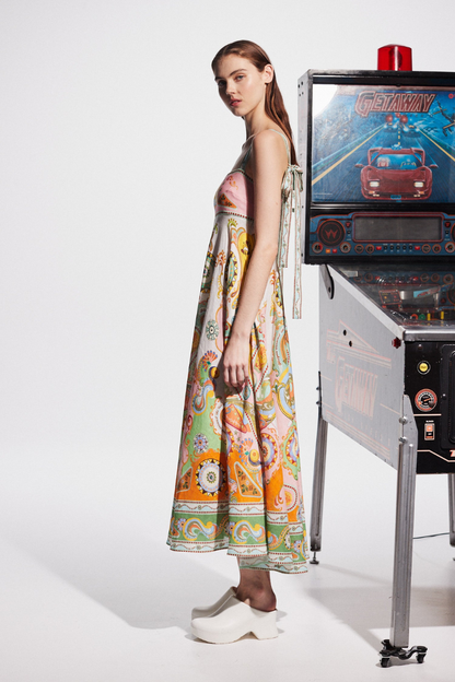 Multicolor - A woman wearing a colourful, sleeveless midi dress with a square neckline, empire waist, and an intricate psychedelic bohemian placement print.