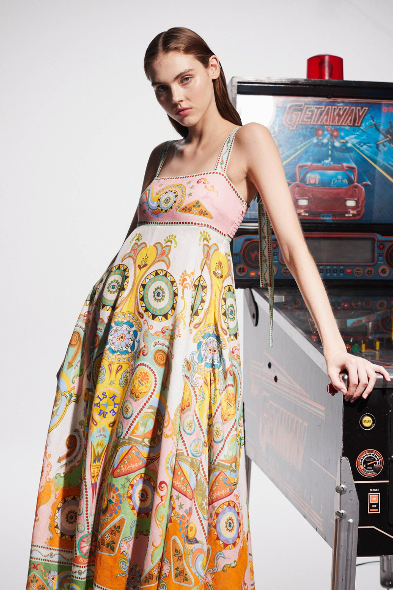 Multicolor - A woman wearing a colourful, sleeveless midi dress with a square neckline, empire waist, and an intricate psychedelic bohemian placement print.
