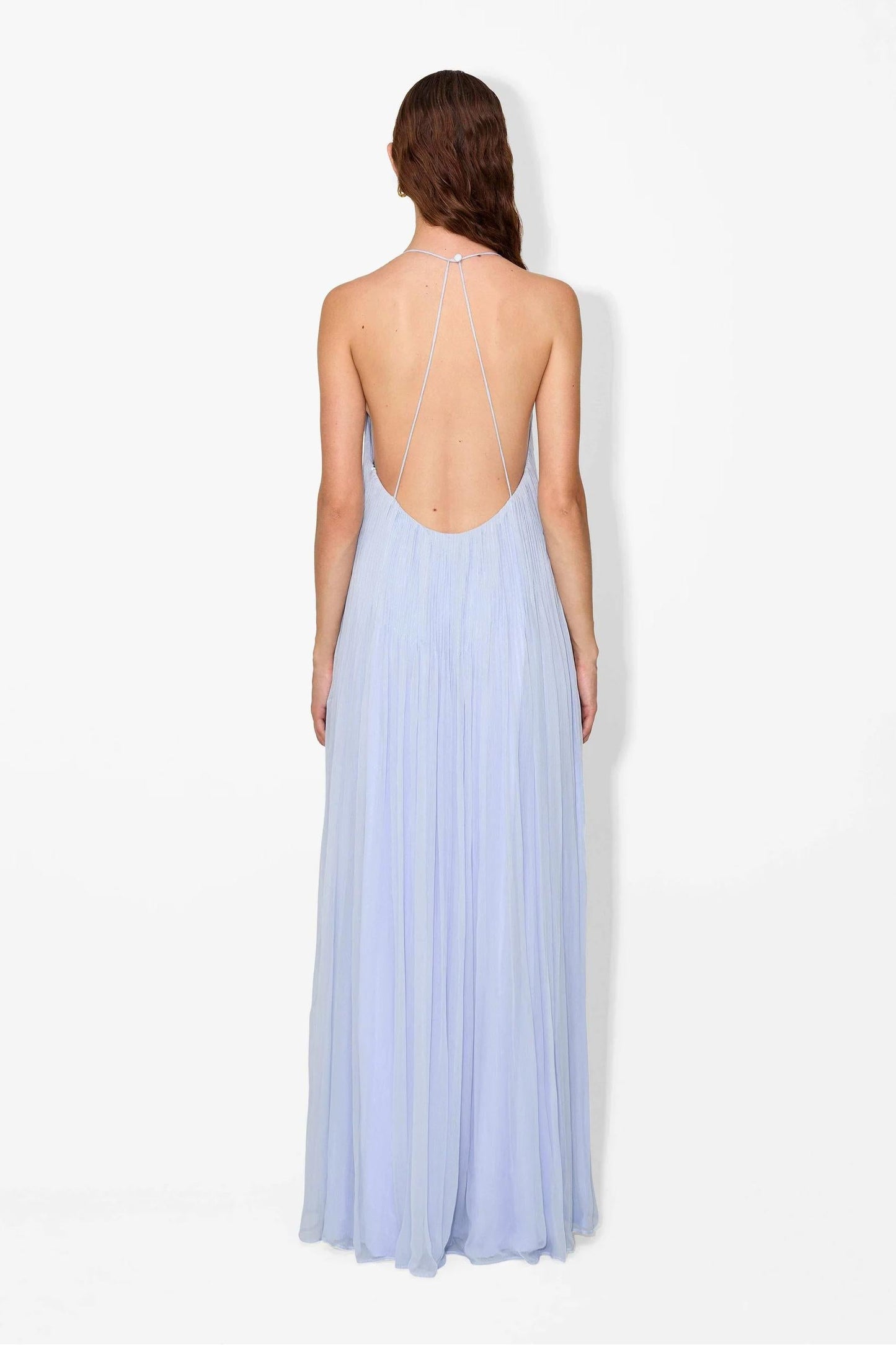Hydrangea - Front view of a woman modelling a light blue, floor-length pleated maxi dress featuring a V-neckline and thin straps.