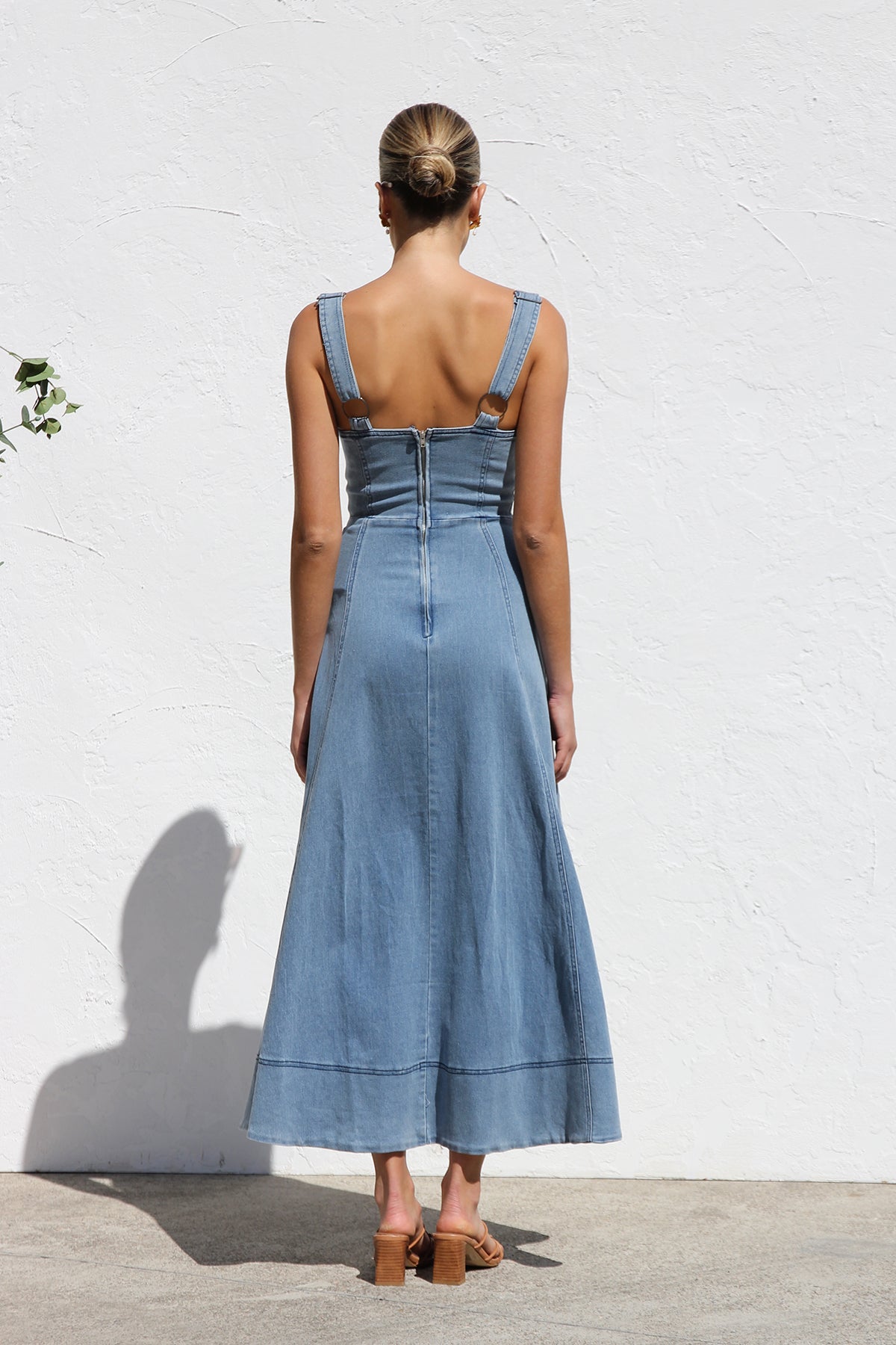 Women's blue structured midi dress featuring a full button-front, wide straps, sweetheart neckline, and front patch pockets.