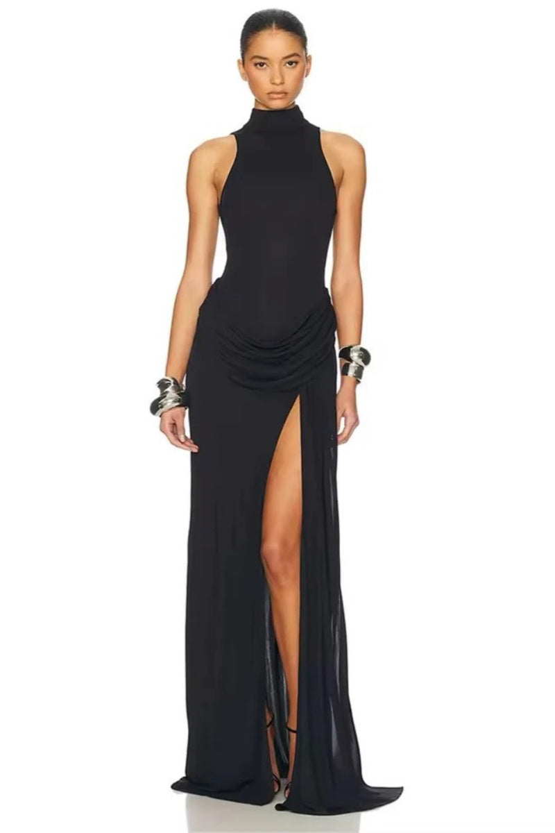 Black - A woman wearing an elegant, floor-length white evening dress featuring a high neckline, sleeveless design, draped hip detailing, and a dramatic thigh-high slit.