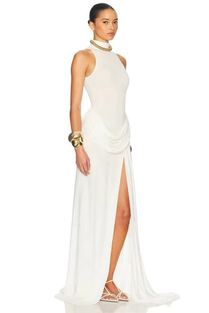 White - A woman wearing an elegant, floor-length white evening dress featuring a high neckline, sleeveless design, draped hip detailing, and a dramatic thigh-high slit.