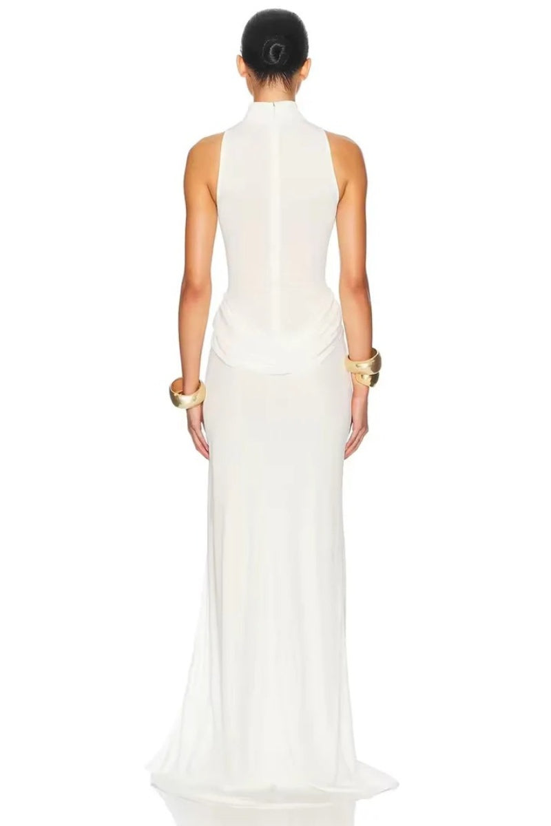 White - A woman wearing an elegant, floor-length white evening dress featuring a high neckline, sleeveless design, draped hip detailing, and a dramatic thigh-high slit.