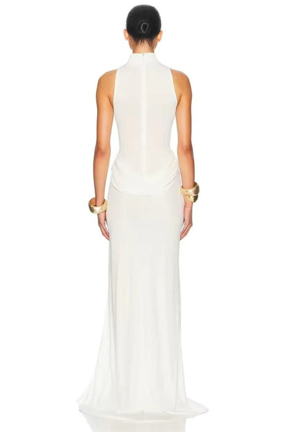 White - A woman wearing an elegant, floor-length white evening dress featuring a high neckline, sleeveless design, draped hip detailing, and a dramatic thigh-high slit.