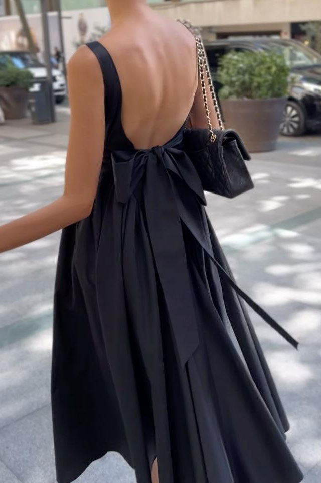 Black - A woman walking outdoors wearing an elegant black sleeveless midi dress featuring a square neckline, fitted bodice, and a full gathered skirt with a dropped waist.