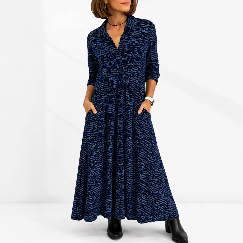 Blue - Woman wearing an abstract print collared maxi shirt dress with front buttons and relaxed fit.