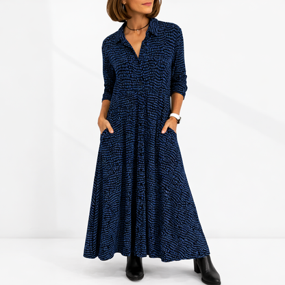 Blue - Woman wearing an abstract print collared maxi shirt dress with front buttons and relaxed fit.