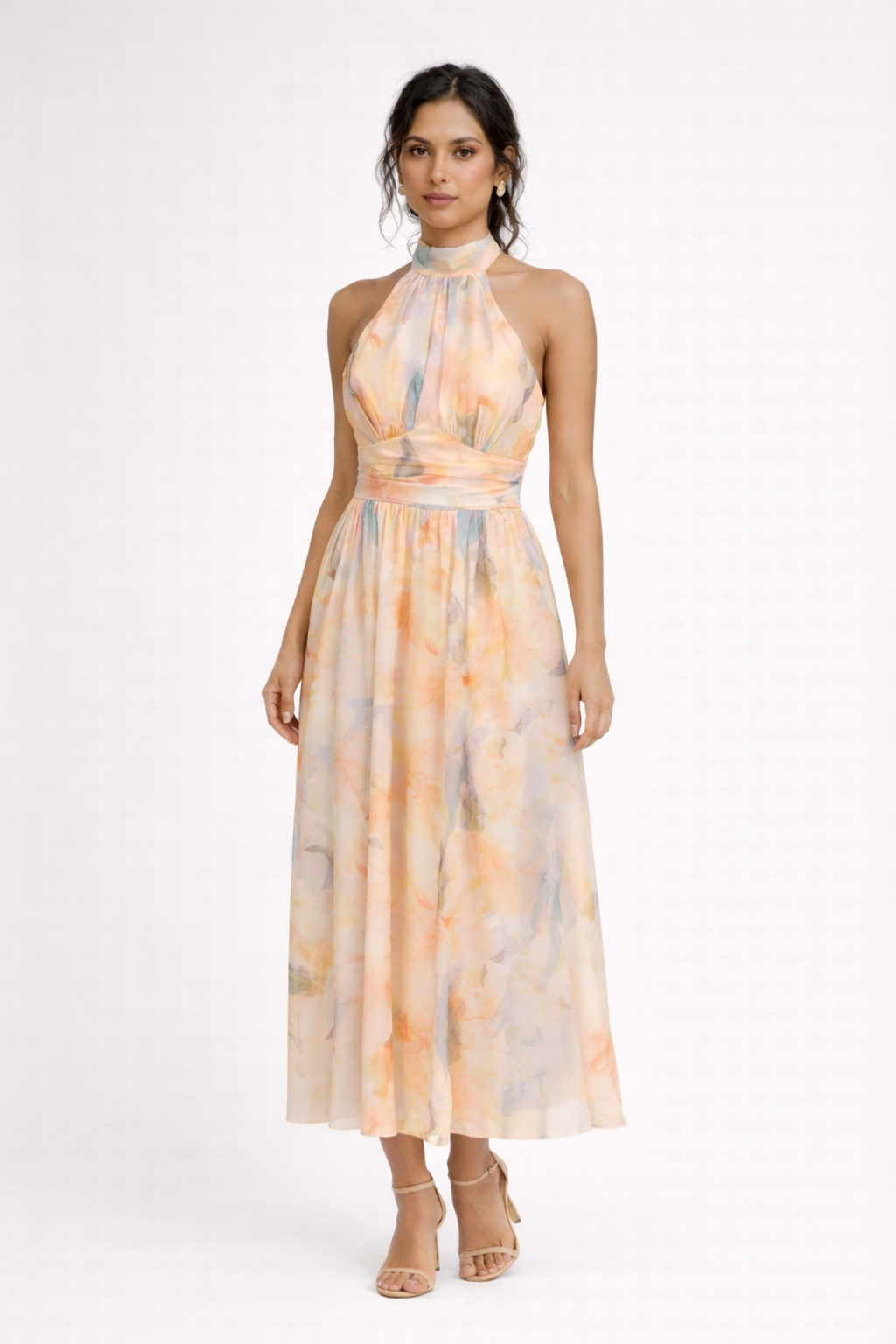 Peach - A model wearing a sleeveless floral halter-neck midi dress with a wide ruched waistband and flowing A-line skirt.