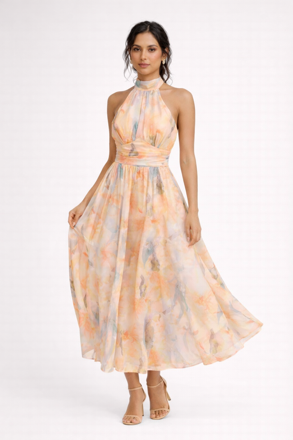 Peach - A model wearing a sleeveless floral halter-neck midi dress with a wide ruched waistband and flowing A-line skirt.
