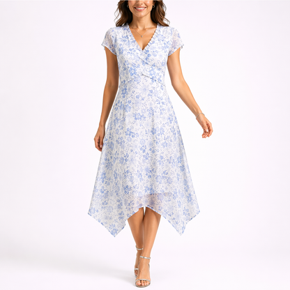 Blue - Woman wearing a floral chiffon V-neck midi dress with cap sleeves and an asymmetric handkerchief hemline.