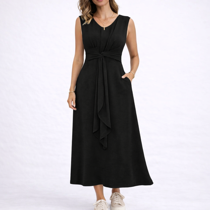 Black - Sleeveless V-neck midi dress featuring a front knot detail and side pockets, styled with trainers on a white background
