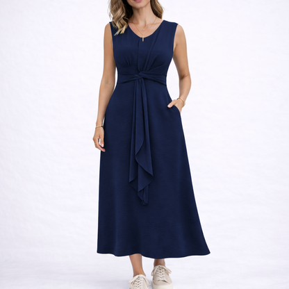Navy - Sleeveless V-neck midi dress featuring a front knot detail and side pockets, styled with trainers on a white background