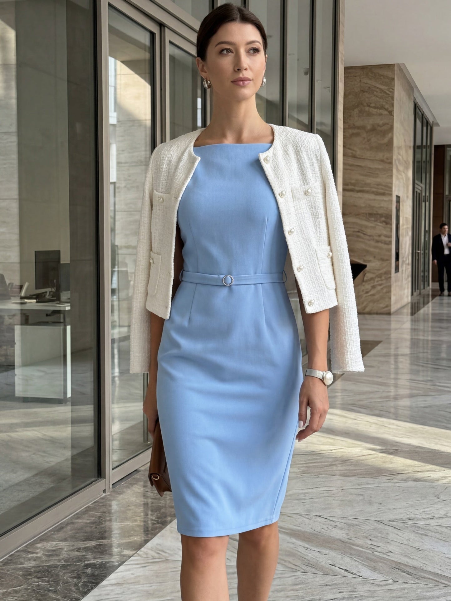 Blue - Model wearing a fitted square-neck midi dress with a matching waist belt in a structured crepe fabric, standing in an elegant room with decorative wall mouldings.