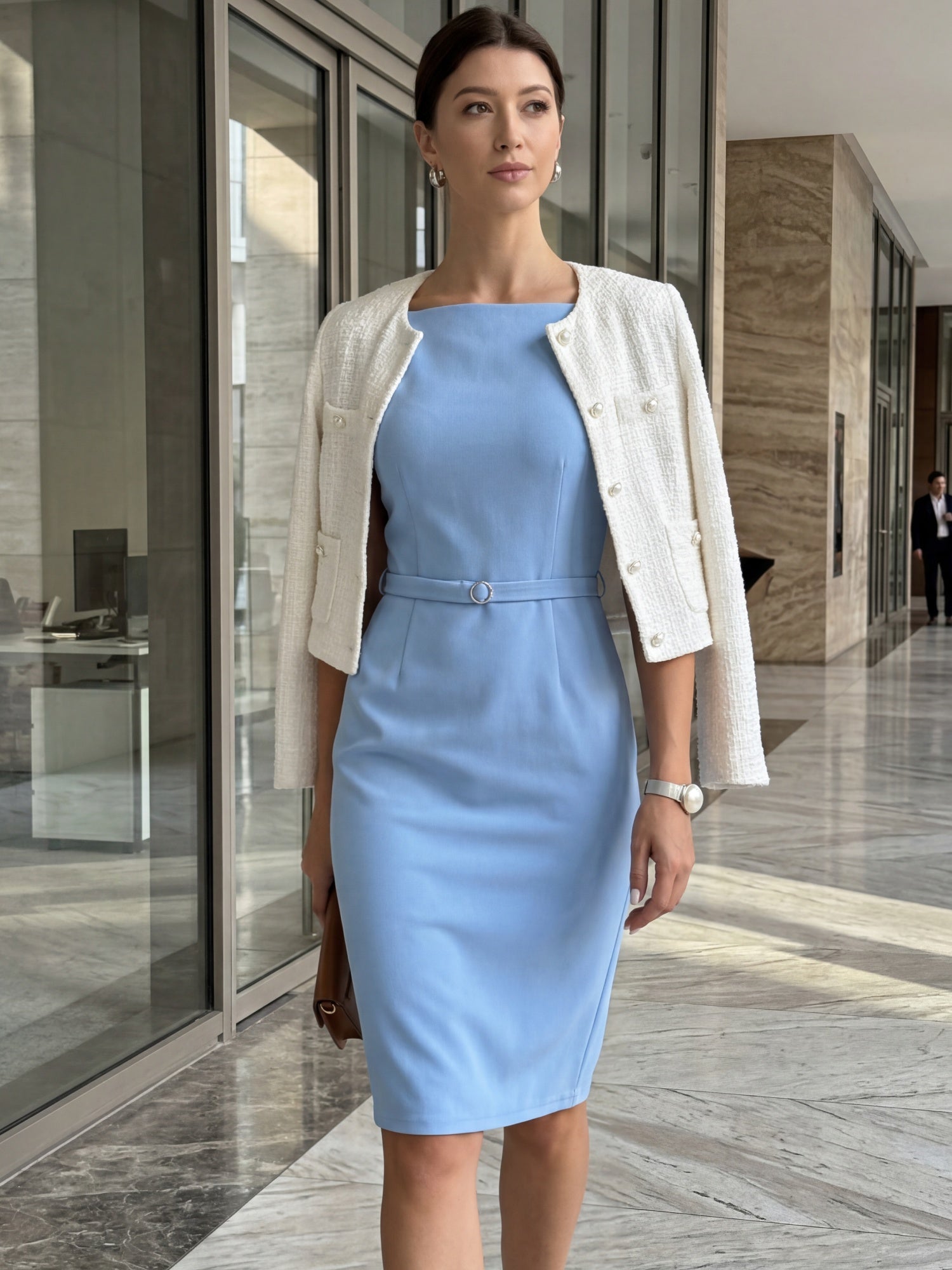 Blue - Model wearing a fitted square-neck midi dress with a matching waist belt in a structured crepe fabric, standing in an elegant room with decorative wall mouldings.