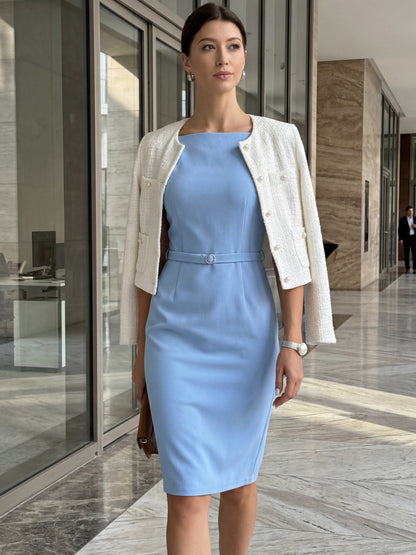 Blue - Model wearing a fitted square-neck midi dress with a matching waist belt in a structured crepe fabric, standing in an elegant room with decorative wall mouldings.