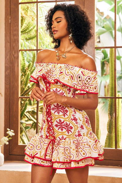 Red - Women's off-the-shoulder mini dress featuring a ruffled neckline, corset-style lace-up front, tiered skirt, and intricate red and gold floral embroidery on a white background.