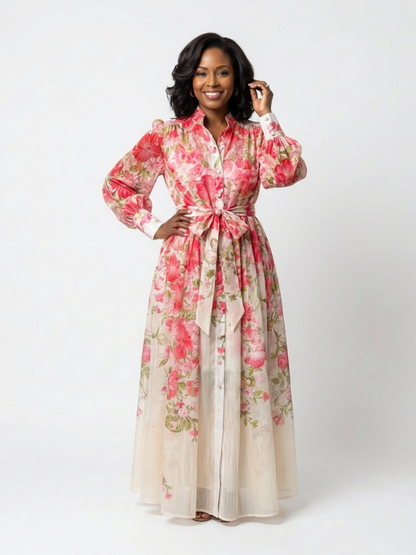 Red - A woman wearing a long-sleeve floral maxi shirt dress with a collared neckline and tie waist, standing against a white background.
