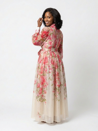 Red - A woman wearing a long-sleeve floral maxi shirt dress with a collared neckline and tie waist, standing against a white background.