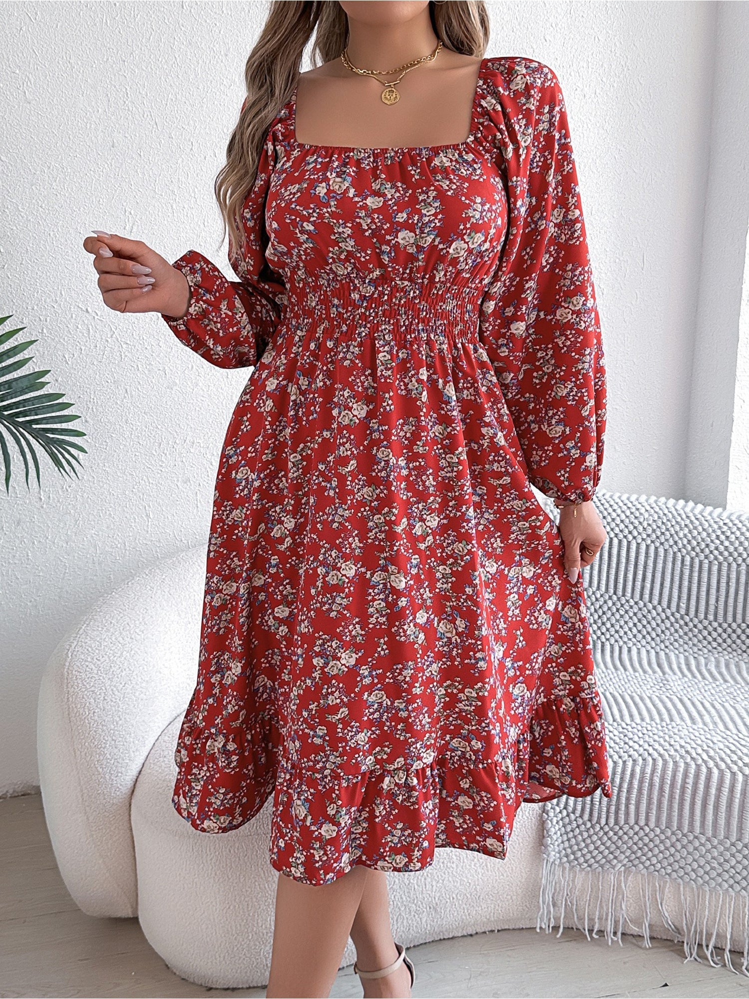 Red - Woman wearing a floral square-neck midi dress with long sleeves, a shirred waist, and a ruffled hem