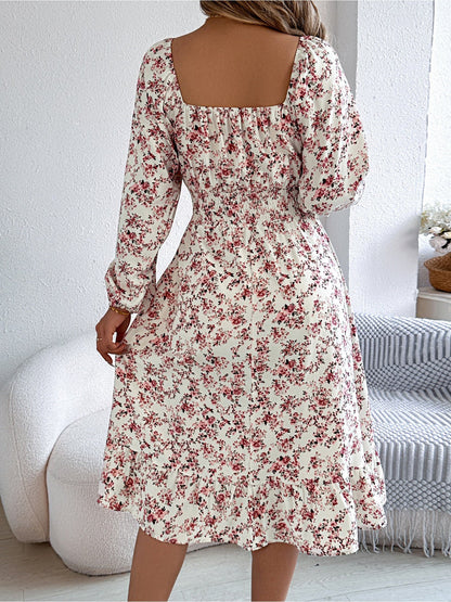 White - Woman wearing a floral square-neck midi dress with long sleeves, a shirred waist, and a ruffled hem