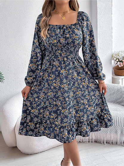 Navy - Woman wearing a floral square-neck midi dress with long sleeves, a shirred waist, and a ruffled hem