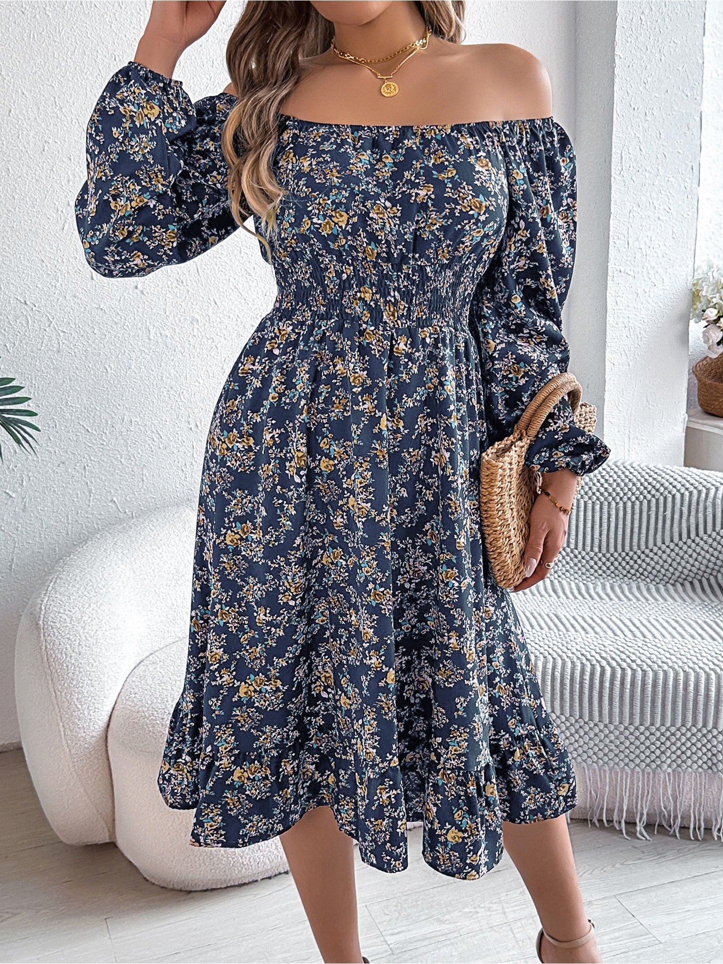 Navy - Woman wearing a floral square-neck midi dress with long sleeves, a shirred waist, and a ruffled hem