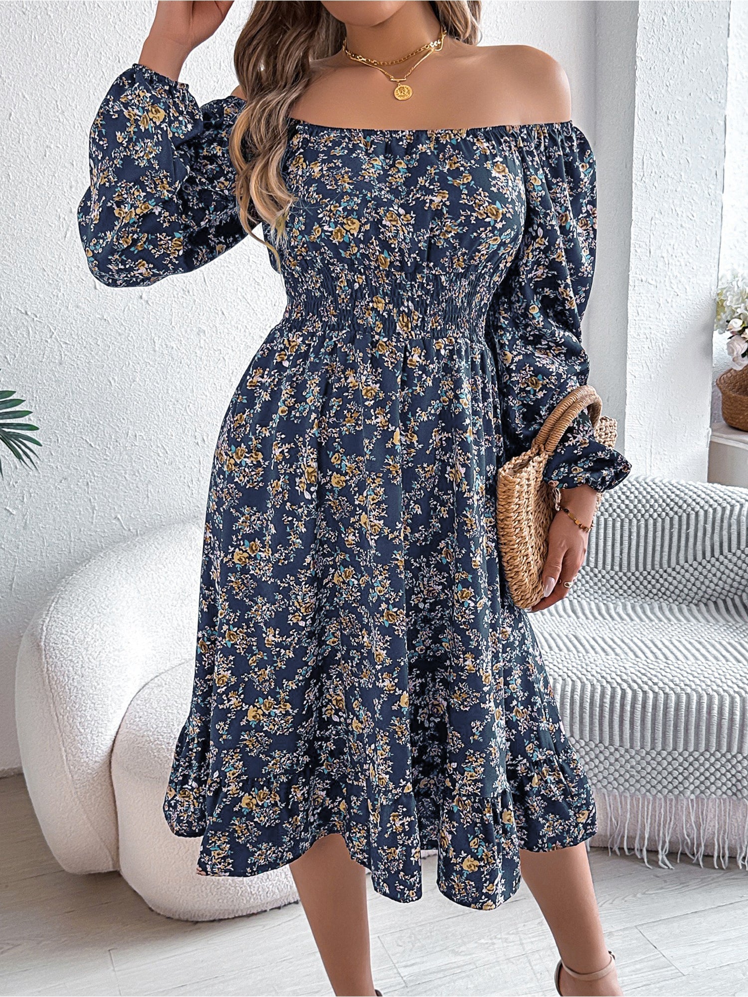Navy - Woman wearing a floral square-neck midi dress with long sleeves, a shirred waist, and a ruffled hem