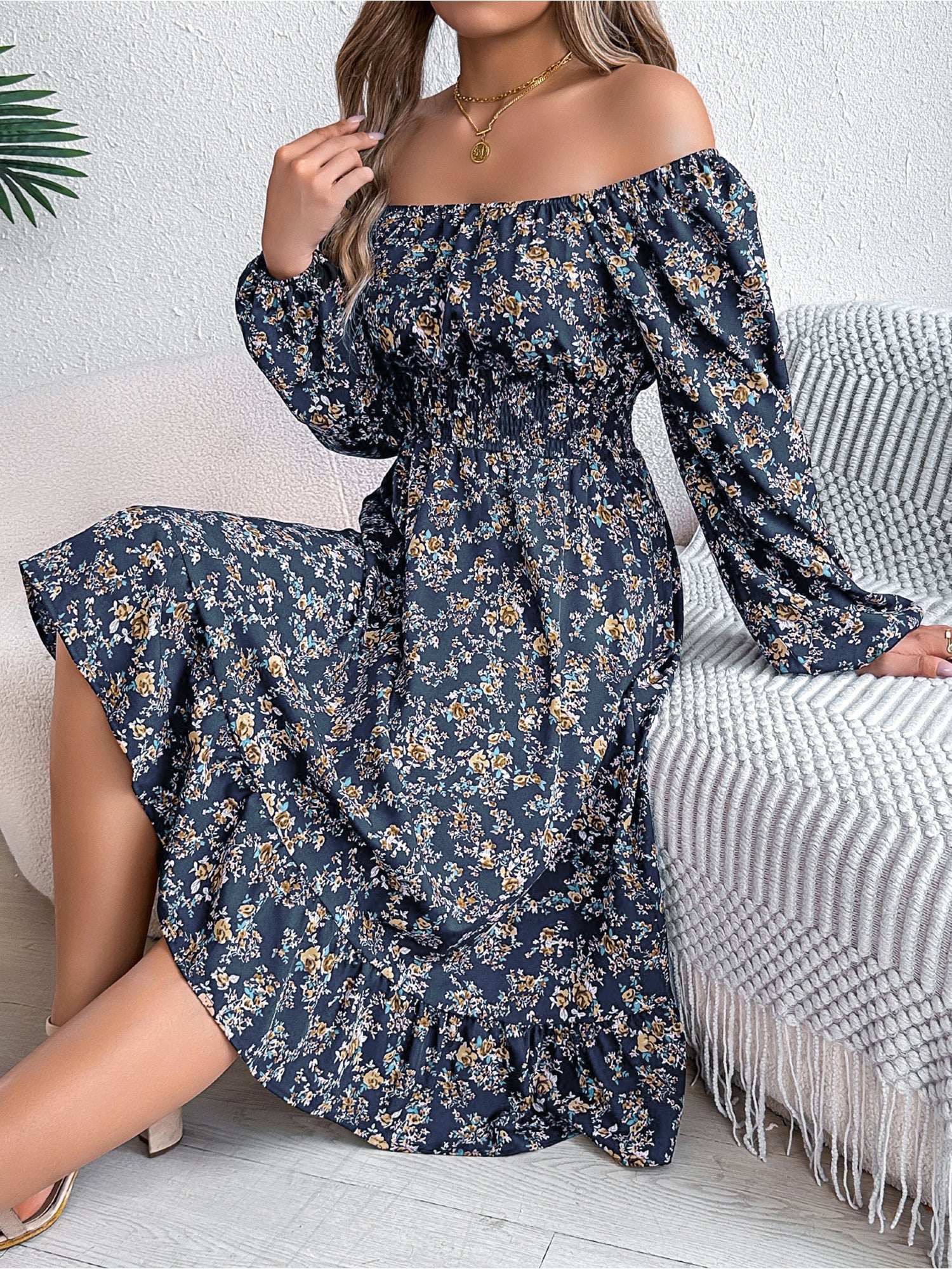 Navy - Woman wearing a floral square-neck midi dress with long sleeves, a shirred waist, and a ruffled hem