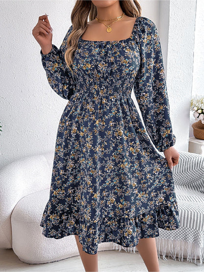 Navy - Woman wearing a floral square-neck midi dress with long sleeves, a shirred waist, and a ruffled hem