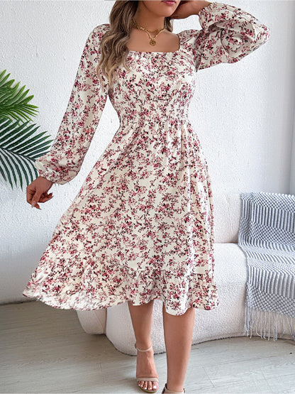 White - Woman wearing a floral square-neck midi dress with long sleeves, a shirred waist, and a ruffled hem