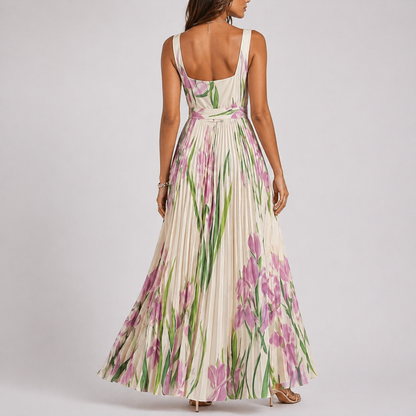 White - A woman wearing a floral pleated maxi dress with a square neckline, wide straps, and a flowing A-line skirt.