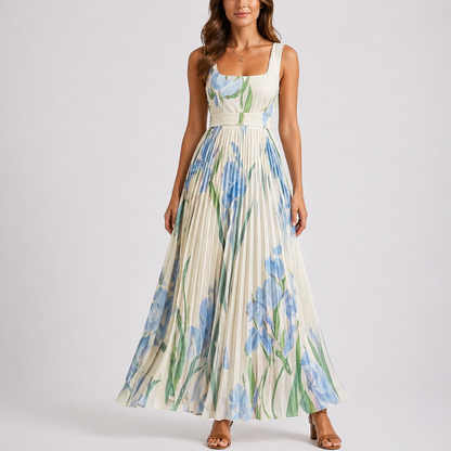 Blue & White - A woman wearing a floral pleated maxi dress with a square neckline, wide straps, and a flowing A-line skirt.