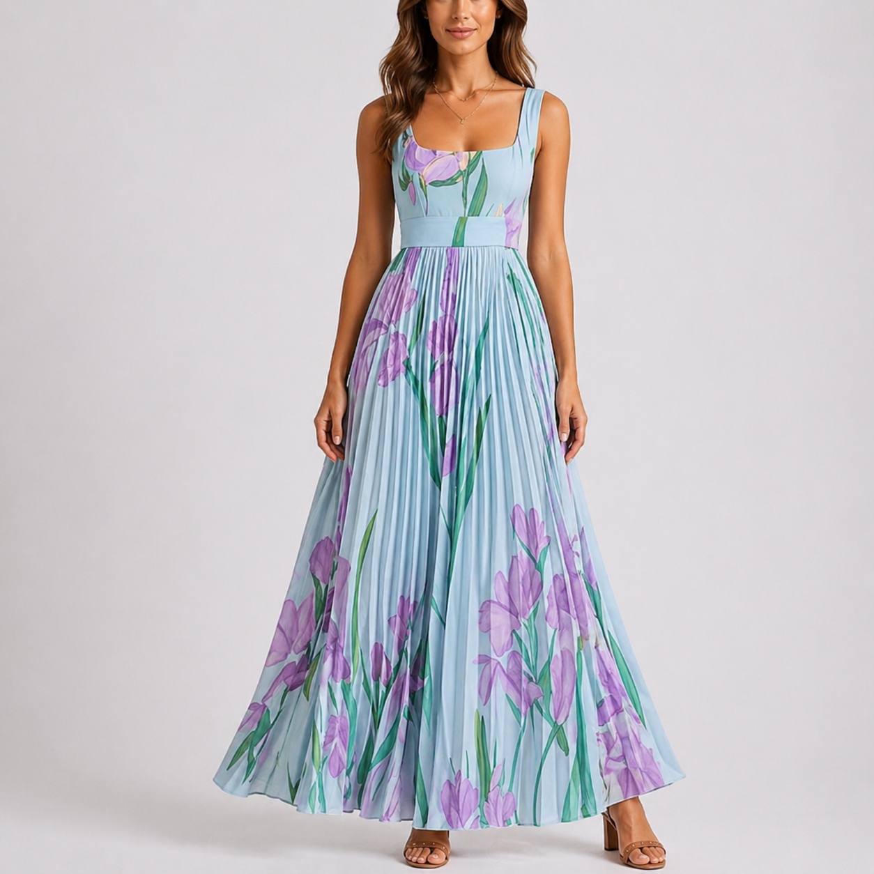 Blue - A woman wearing a floral pleated maxi dress with a square neckline, wide straps, and a flowing A-line skirt.