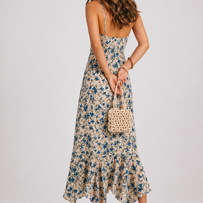 Floral - Model wearing a floral print asymmetric midi dress with spaghetti straps, a tie-front bust, and a ruffled handkerchief hemline.