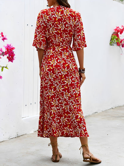 Red - Model wearing a floral V-neck wrap maxi dress with short sleeves and a waist tie, styled with a woven tote bag and sandals.