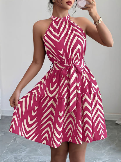 Rose Red - Woman wearing a geometric patterned halter-neck mini dress with a tie waist and tiered skirt.